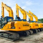a row of yellow and blue construction machines